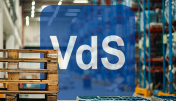 A pallet in a warehouse next to a VdS logo