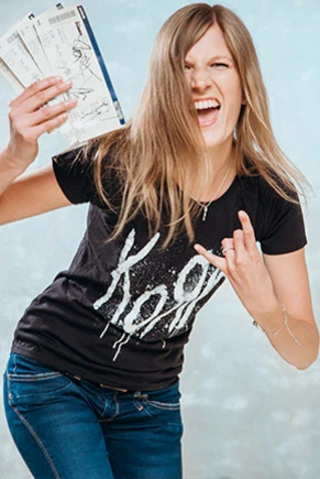 Woman in black T-shirt with concert tickets in hand