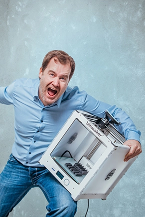 Man holds a 3D printer