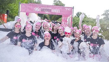 13 women in a mountain of foam at the Muddy Angel Run
