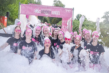 13 women in a mountain of foam at the Muddy Angel Run